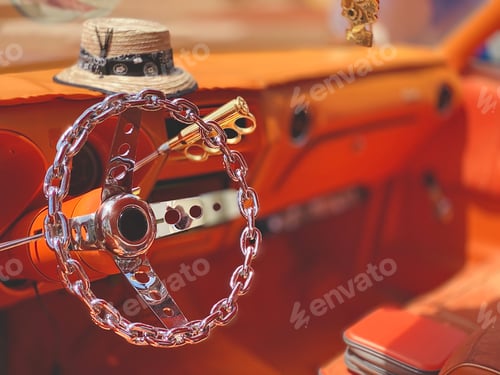 Preview: Custom low rider with silver chain steering wheel and orange interior ready for street cruising