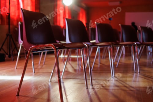 Preview: Chairs and seats in a meeting room for an event with red ambiance