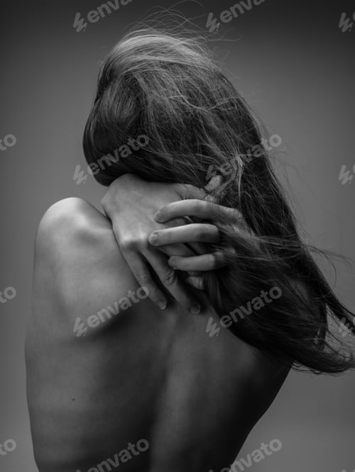 Preview: The woman in the gray photograph is touching herself with her bare back