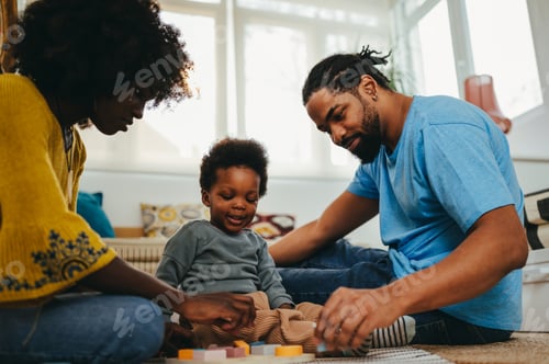 Preview: Dedicated african american parents are in the living room with their son and teaching him shapes
