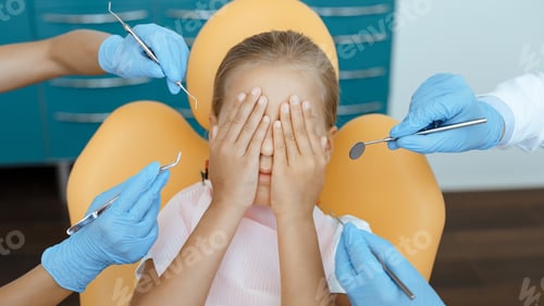 Preview: Child Covering Eyes at the Dentist Office