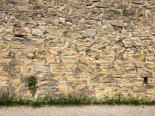 Preview: Bronze age stone wall texture invaded by some green grasses