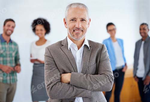 Preview: I have a team of winners. Mature man standing proudly in front of his team.