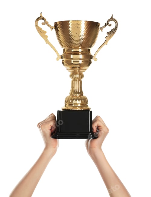 Preview: Young woman holding gold trophy cup on white background, closeup