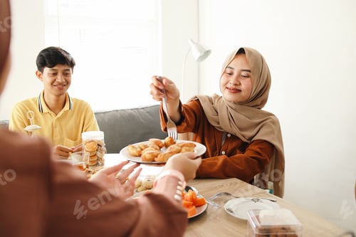 Preview: Muslim Woman Serving Food to Friends on Iftar Ramadan