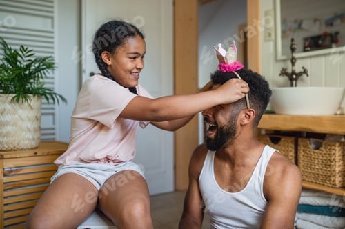 Preview: Happy young father with small daughter indoors at home, having fun in bathroom
