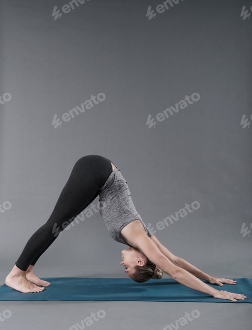 Preview: Young woman practising yoga, grey background