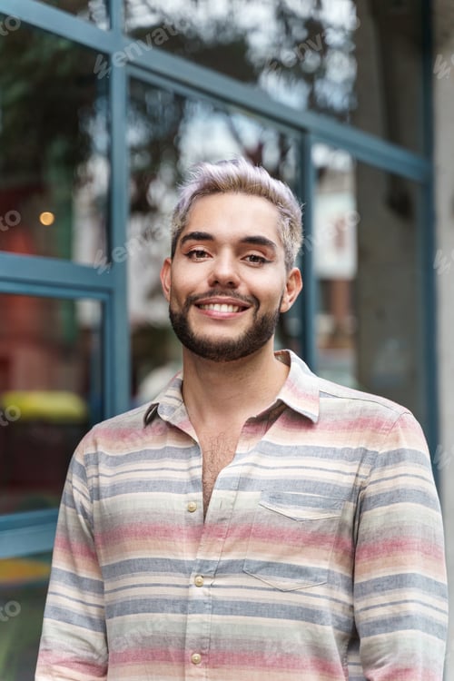 Preview: confident young man with trendy casual wear looking to the camera. Gay LGBT person