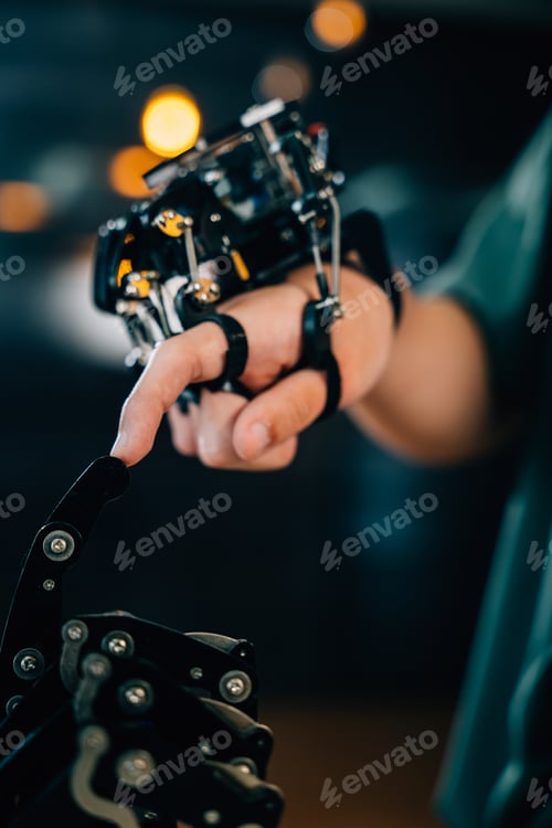 Preview: In a technical college setting a teenage boy tests a robot hand and arm touching fingers for