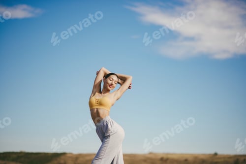 Preview: Active Woman Stretching with Blue Sky Background