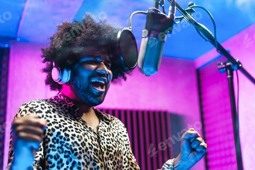 Preview: Young professional afro singer recording a new song album inside music production studio