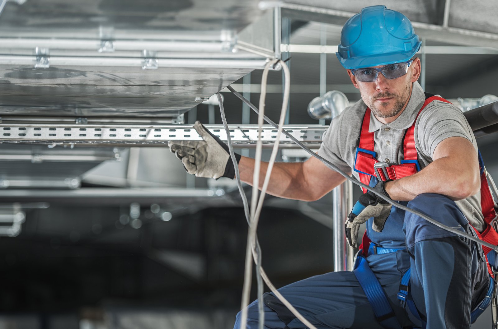 Équipe d'installation de conduits de ventilation sur un chantier commercial