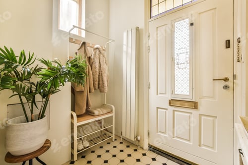 Preview: a small bathroom with a white door and a plant