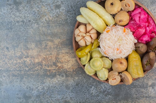 Preview: Salty vegetables in wooden bowl on marble background