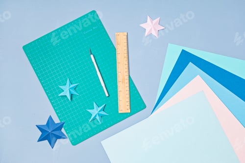 Preview: Top view over paper cut tools, scissors, cutter, cutting mat and paper