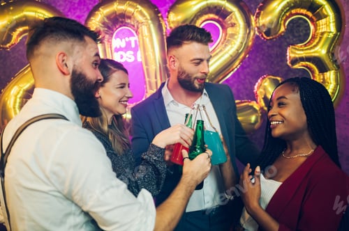 Visualização: Pessoas multirraciais brindando bebidas enquanto comemoram a véspera de ano novo no clube
