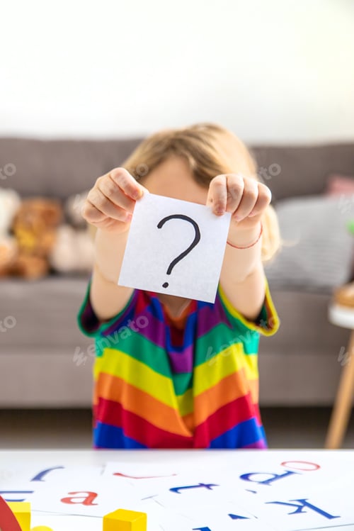 Preview: Question mark in the hands of a child. Selective focus.
