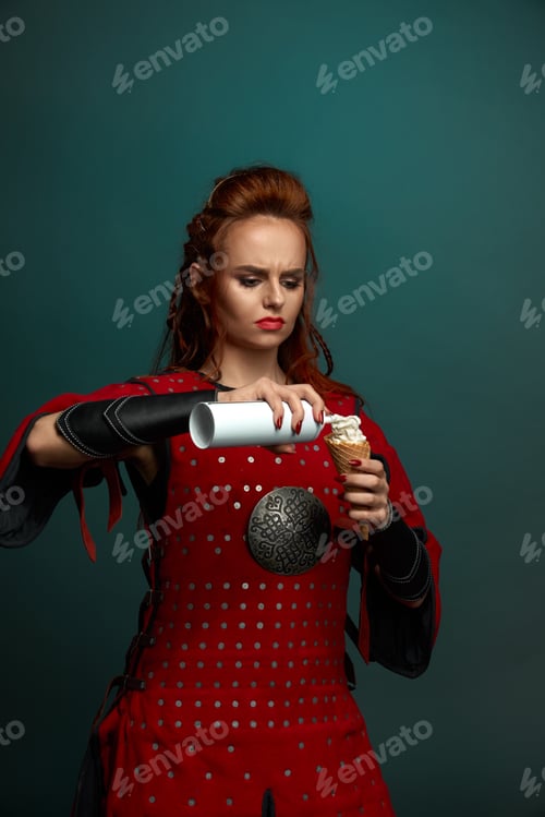 Preview: Red haired female warrior eating delicious ice cream