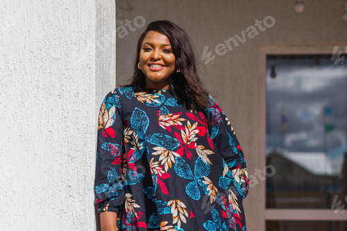 Preview: African american woman relaxing and enjoying sun while standing at terrace or balcony at sunlight at