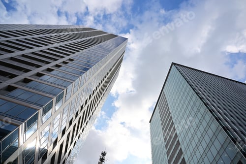 Preview: Low angle shot of modern glass skyscrapers against the cloudy sky