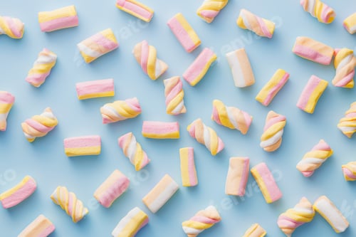 Preview: Sweet colorful marshmallows on blue background. Top view.