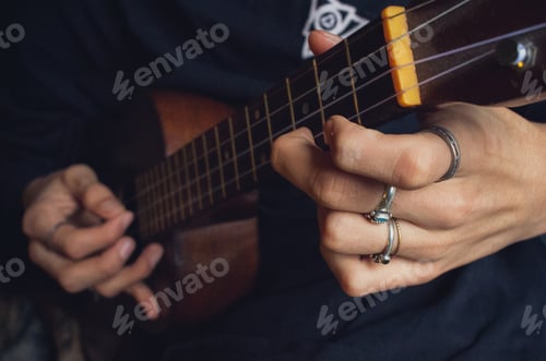 Preview: hands playing music with ukulele instrument