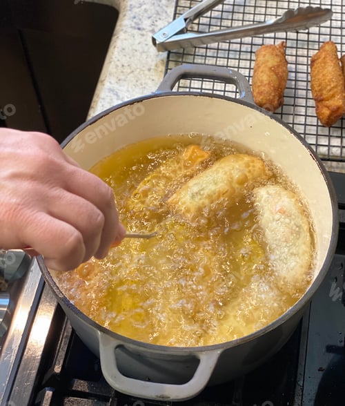 Preview: Person taking temperature of food while it’s cooking