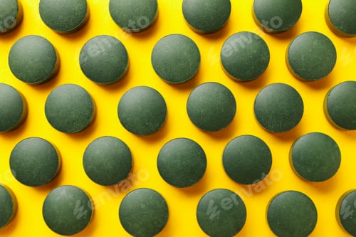 Preview: Flat lay with spirulina pills on yellow background, top view