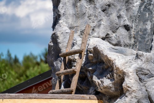 Preview: Closeup shot of a wooden ladder leaning on a stone wall
