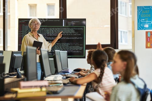 Preview: Senior Caucasian Woman Teaching Coding to Diverse Group of Children in Classroom