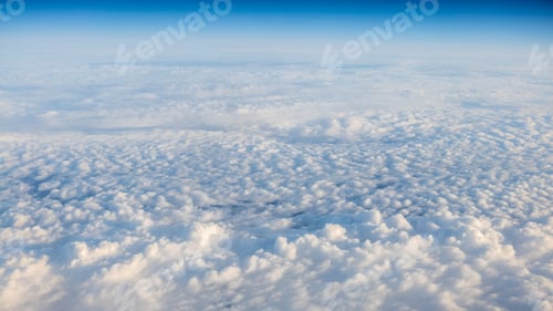 Preview: The beautiful cloudscape with clear blue sky. A view from airplane window.