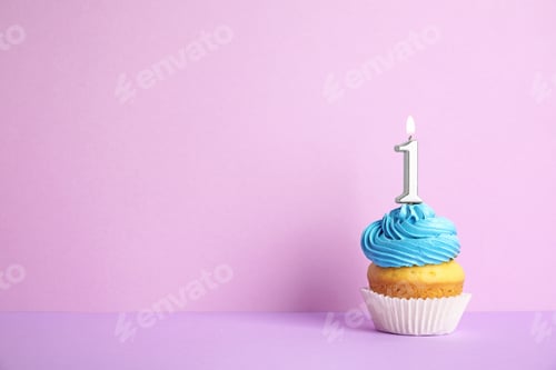 Preview: Birthday cupcake with number one candle on violet background, space for text