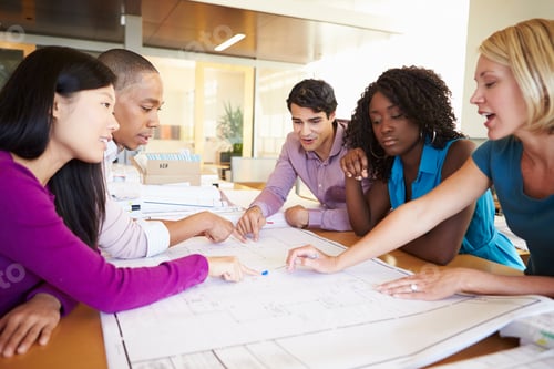 Preview: Group Of Architects Discussing Plans In Modern Office