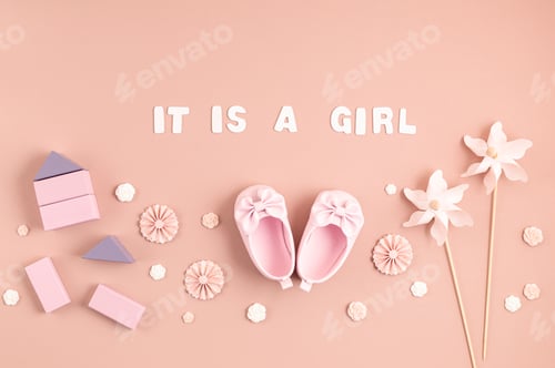 Preview: Cute newborn baby girl shoes with festive decoration over pink background. Baby shower, birthday