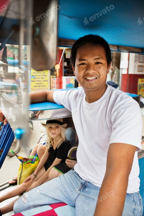 Preview: Smiling pedicab driver with passengers