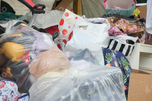 Preview: dumped donated items in a large container outdoor