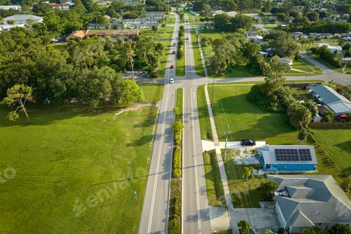 Preview: Aerial view of street traffic with driving cars in small town America suburban landscape