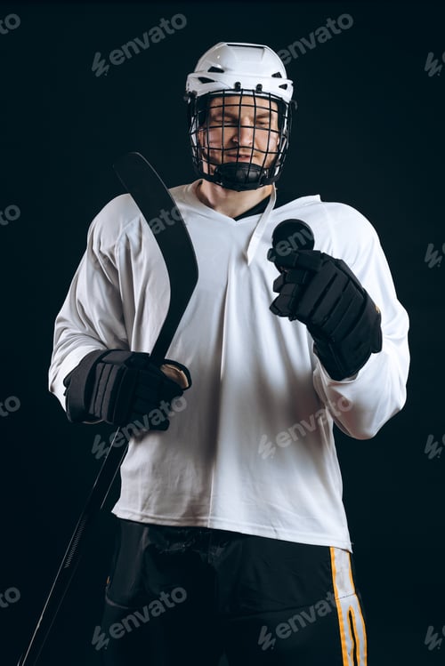 Preview: Handsome hockey player. Smiling at camera isolated on black background.