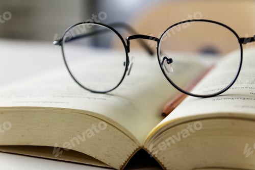 Preview: Reading glasses placed on open books