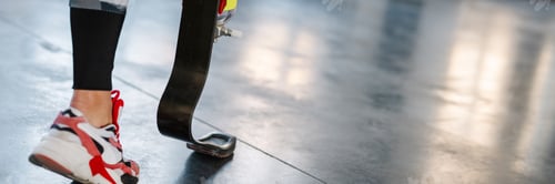 Preview: Young sportswoman with prosthesis working out indoors