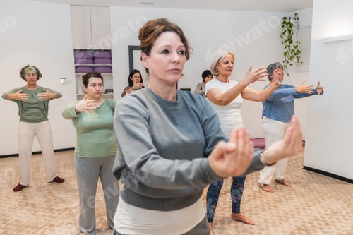 Preview: Senior women practicing arm stretches during a yoga session focused on mindfulness