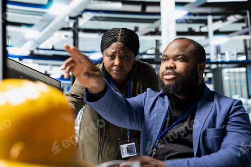Preview: Solar energy specialists team reviewing production line activity on pc