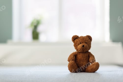 Preview: Tiny plush teddy bear toy sitting on the bed