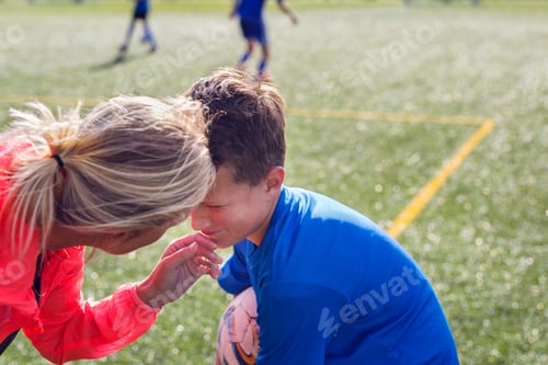 Preview: Mother comforting son (12-13) during soccer practice