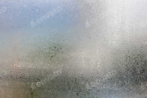 Preview: Misted glass, silver rain drops dew drops on transparent glass window.