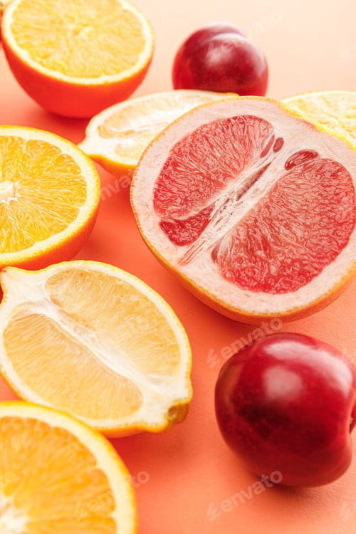 Preview: Citrus halves and apples on orange background