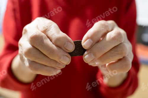 Preview: hands of old country woman are holding candy