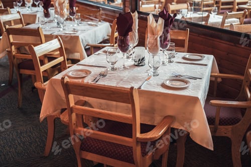 Preview: Rustic style of wooden dining table with tableware, glassware and napery