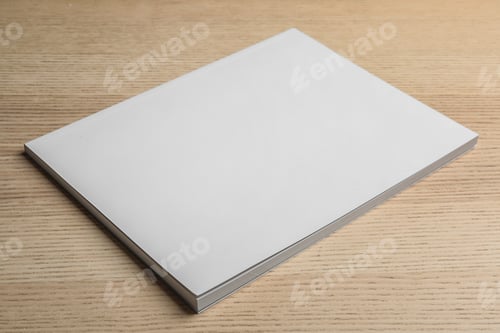 Preview: Brochure with blank cover on wooden background. Mock up for design