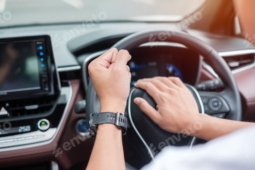 Preview: man driver honking a car during driving on traffic road, hand controlling steering wheel in vehicle.